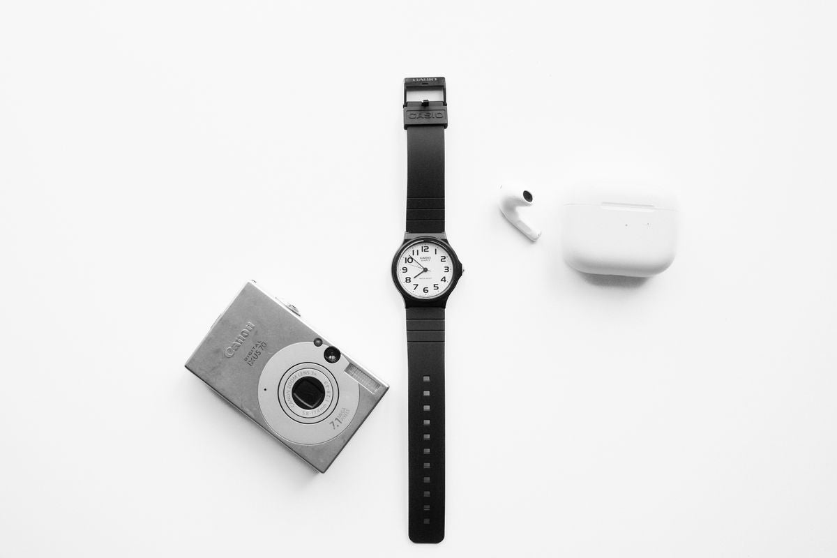Accessories category - watch camera and earbuds flat lay