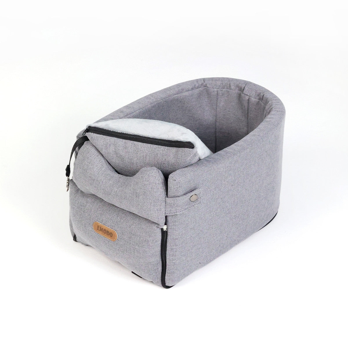 Small dog sitting inside the portable car seat carrier